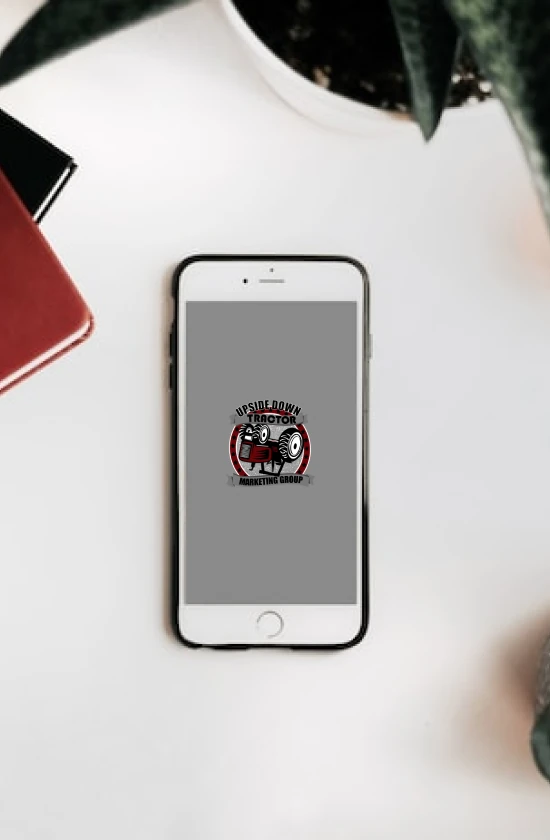 A phone with our website logo sitting on an office desk.